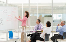 Woman at a whiteboard leading a focus group