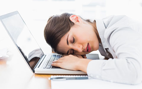 woman sleeping on laptop
